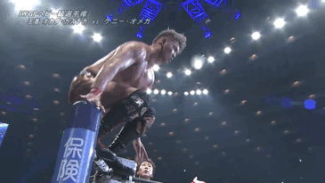 Gif from the match of Okada elbow dropping an elbow on Kenny, who is splayed on a table outside the ring. 