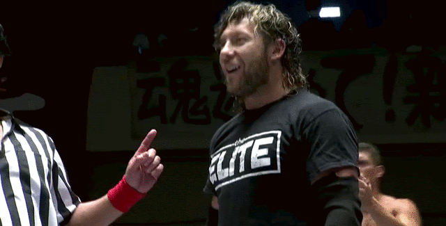 Gif of the warm-up match. Kenny is standing in the ring, beckoning Okada to come to him.