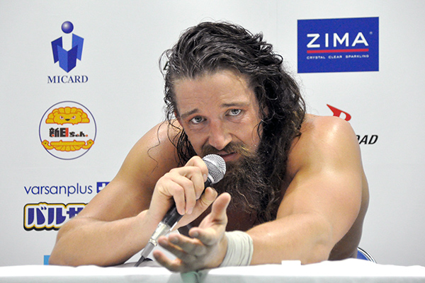 Jay White addressing the camera, looking emotional in a post-match interview