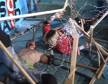 A clip from the match: Ito and Hido on the floor outside the ring, having crashed through barbed wire. 