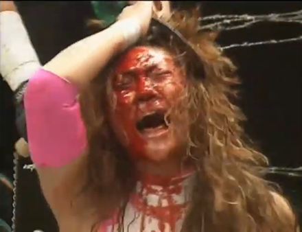 A blood stained face of Megumi Kudo, mid-match
