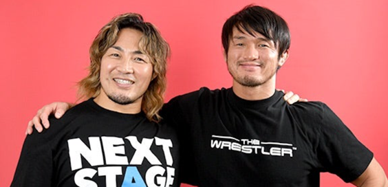 Shibata and Tana smiling, arms around each others shoulders.