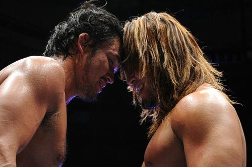 Tanahashi and Shibata, foreheads pressed together in an aggressive stance. 