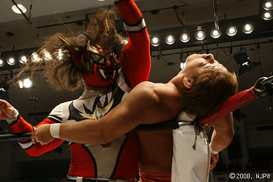 Liger attacking YUJIRO in the corner of the ring