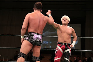 Kenoh and Sugiura in the ring, bumping fists