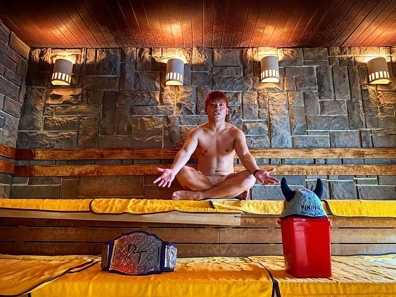 Shunma sitting in a sauna with his extreme title