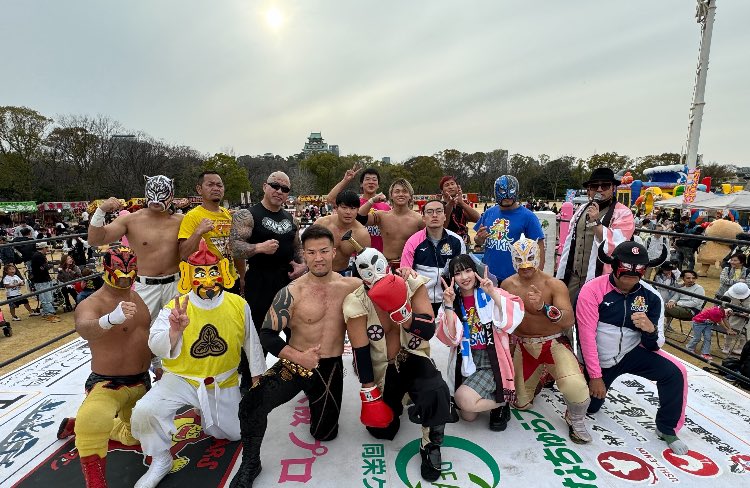 Image of Osaka Pro Wrestling roster gathered in a wrestling ring and posing together.